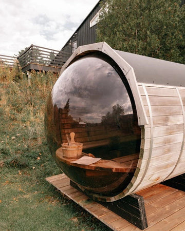 outdoor traditional sauna barrel shaped with dome window in front