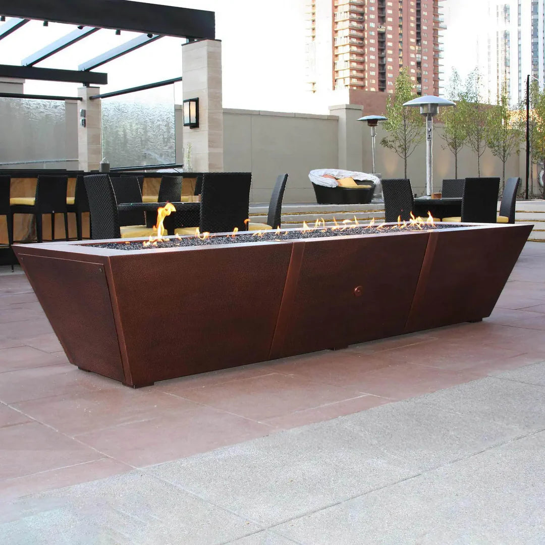 large fire pit table in copper with low flames